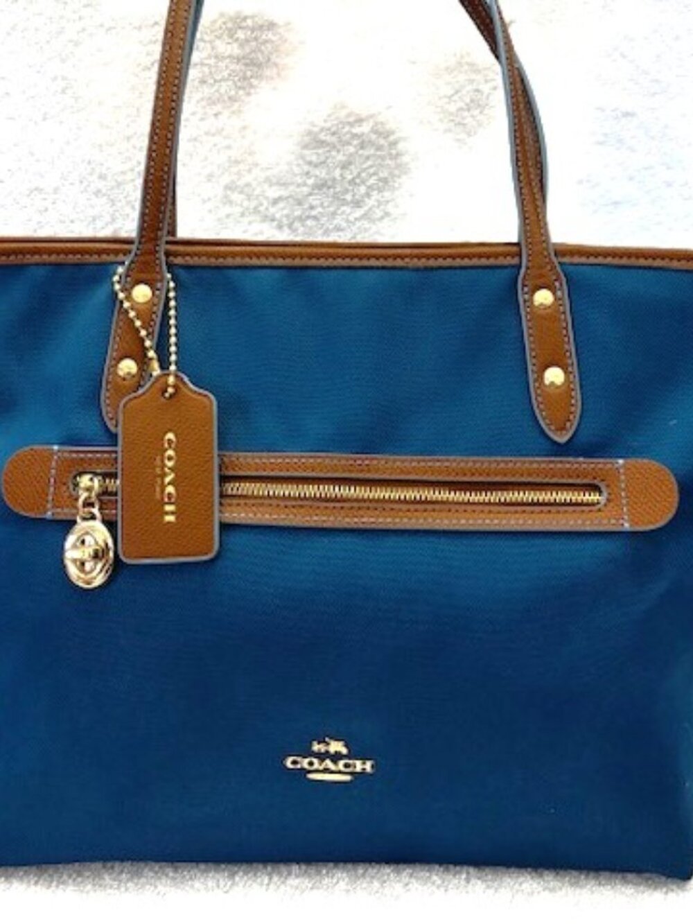 Coach Sawyer Tote in a bright blue nylon canvas with brown leather accents